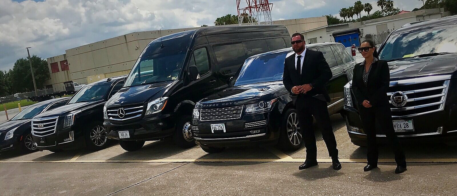 Jan-Lee protection agents beside a fleet of executive vehicles